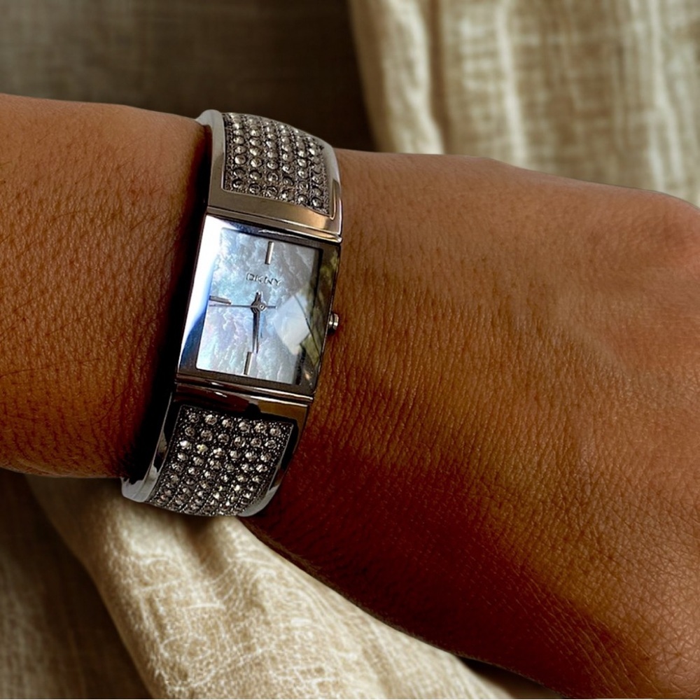 New DKNY mother of peal face and stainless steel strap.